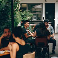 2019-11-15-hrexaminer-article-joe-gerstandt-how-inclusion-happens-photo-img-cc0-by-Helena-Lopes-via-pexels-people-sitting-at-the-table-3215526-sq-200px.jpg